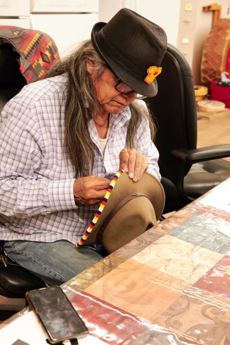 Elder Eugene beading a hat